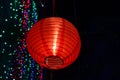 Beautiful red paper lantern against colourful bokeh