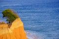 Beautiful red rocks on the beach Praia da Falesia Barranco das Belharucas