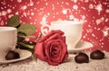 Beautiful red rose and cup of hot tea with chocolate Royalty Free Stock Photo
