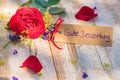 Flowers and card with german text, Gute Besserung, means get well soon