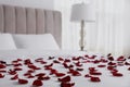 Beautiful red rose petals on bed in room Royalty Free Stock Photo