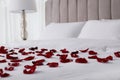 Beautiful red rose petals on bed in room Royalty Free Stock Photo