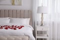 Beautiful red rose petals on bed in room Royalty Free Stock Photo