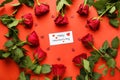 Beautiful red roses and card on color background. Valentines Day celebration Royalty Free Stock Photo