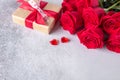 Beautiful red roses, gift box and decorative hearts on stone background. Valentine`s day concept Royalty Free Stock Photo