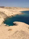 Beautiful Red Sea with azure water and small white car on the road in the desert Royalty Free Stock Photo