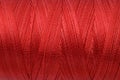 Beautiful red sewing thread as background, closeup Royalty Free Stock Photo