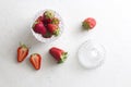 Beautiful red strawberry in glass round bowl Close up. Strawberries on a light white concrete background. Rustic style. Cut Royalty Free Stock Photo