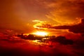 Beautiful red sunset above the clouds with rays of light Royalty Free Stock Photo