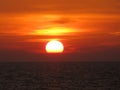 beautiful red sunset over the ocean. Bright sunset with large yellow sun under the sea surface. sundown seascape Royalty Free Stock Photo