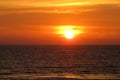 beautiful red sunset over the ocean. Bright sunset with large yellow sun under the sea surface. sundown seascape Royalty Free Stock Photo
