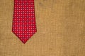 Beautiful red tie on the old sacking Royalty Free Stock Photo