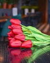 Beautiful red tulips laying on the table in restaurant or bar