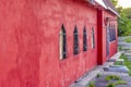 Beautiful red wall of the building. Red building with unusual Windows. Royalty Free Stock Photo
