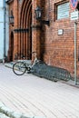 Riga, Latvia, November 2019. Bicycle parking at the wall of a medieval cathedral.