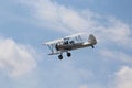 Red, White, and Blue Biplane Flying in the Clouds Royalty Free Stock Photo