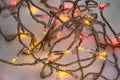 The beautiful red and yellow LED lights garlands of burning colorful lamps on a snow background in the holiday evening Royalty Free Stock Photo