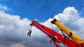 Beautiful red and yellow telescopic crane with blue sky with cloud for background. Royalty Free Stock Photo