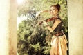 Beautiful redhair woman with body art on her face playing on violin outdoors.