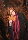 Beautiful redhaired girl with a leaf.