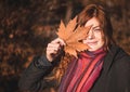 Beautiful redhaired girl with a leaf.