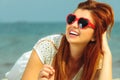 Beautiful redhaired girl in sunglasses on beach, portrait Royalty Free Stock Photo