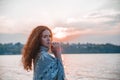 Beautiful red-haired girl at sunset. Royalty Free Stock Photo