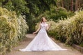 Beautiful redhead Bride in fantastic wedding dress in blooming garden. Royalty Free Stock Photo