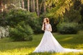 Beautiful redhead Bride in fantastic wedding dress in blooming garden. Royalty Free Stock Photo