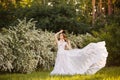 Beautiful redhead Bride in fantastic wedding dress in blooming garden. Royalty Free Stock Photo