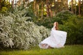 Beautiful redhead Bride in fantastic wedding dress in blooming garden. Royalty Free Stock Photo