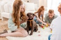 Beautiful redhead family with puppy playing with constructor on floor at home Royalty Free Stock Photo