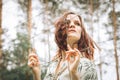 Beautiful redhead girl behind fence outdoors. Royalty Free Stock Photo