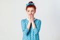 Beautiful redhead girl in blue dress doesn`t want to spread rumors or some confidential information.