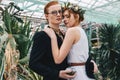 beautiful redhead girl in floral wreath and white dress embracing young man Royalty Free Stock Photo