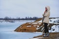 Beautiful redhead girl stays against Nordic landscape