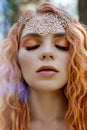 Beautiful redhead Norwegian girl with big eyes and freckles on face in the forest. Portrait of redhead woman closeup in nature Royalty Free Stock Photo