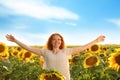 Beautiful redhead woman in sunflower field on sunny day Royalty Free Stock Photo