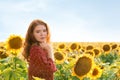 Beautiful redhead woman in sunflower field on sunny day Royalty Free Stock Photo