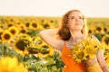 Beautiful redhead woman in sunflower field on sunny day Royalty Free Stock Photo