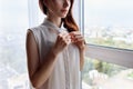 Redhead woman unbuttoning white blouse at home. Royalty Free Stock Photo