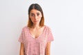 Beautiful redhead woman wearing casual striped red t-shirt over isolated background depressed and worry for distress, crying angry