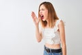 Beautiful redhead woman wearing casual t-shirt standing over isolated white background shouting and screaming loud to side with Royalty Free Stock Photo