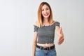 Beautiful redhead woman wearing casual t-shirt standing over isolated white background smiling friendly offering handshake as Royalty Free Stock Photo