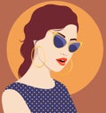 Beautiful redhead woman wearing fashionable sunglasses and polka dot dress