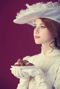 Beautiful redhead women with candy. Royalty Free Stock Photo