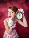 Beautiful redhead women with clock. Royalty Free Stock Photo