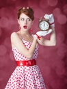 Beautiful redhead women with clock. Royalty Free Stock Photo