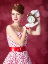 Beautiful redhead women with clock. Royalty Free Stock Photo