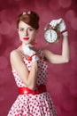 Beautiful redhead women with clock. Royalty Free Stock Photo